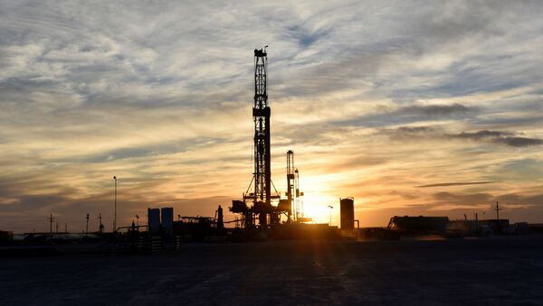 Drilling rigs operate at sunset in Midland, Texas, U.S., February 13, 2019 - Sputnik International