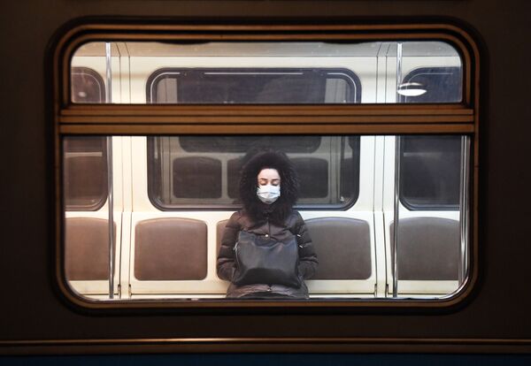 A young woman riding a train in Moscow metro. - Sputnik International