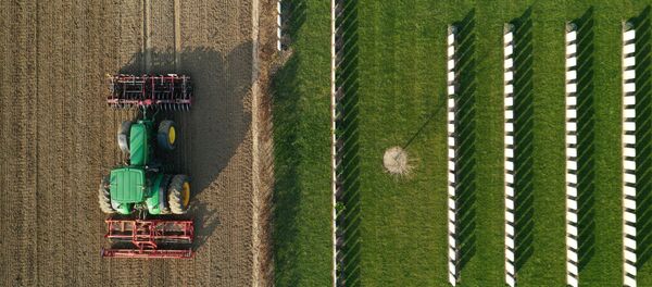 A French farmer drives his tractor to prepare the land before sugar beets sowing in Anneux, France, March 27, 2020. France appealed on Tuesday to workers laid off by the coronavirus (COVID-19) crisis to help farmers pick fruit and vegetables that will otherwise be left to rot in the fields due to a shortage of seasonal workers. Picture taken with a drone A French farmer drives his tractor to prepare the land before sugar beets sowing in Anneux, France, March 27, 2020. France appealed on Tuesday to workers laid off by the coronavirus (COVID-19) crisis to help farmers pick fruit and vegetables that will otherwise be left to rot in the fields due to a shortage of seasonal workers. Picture taken with a drone - Sputnik International