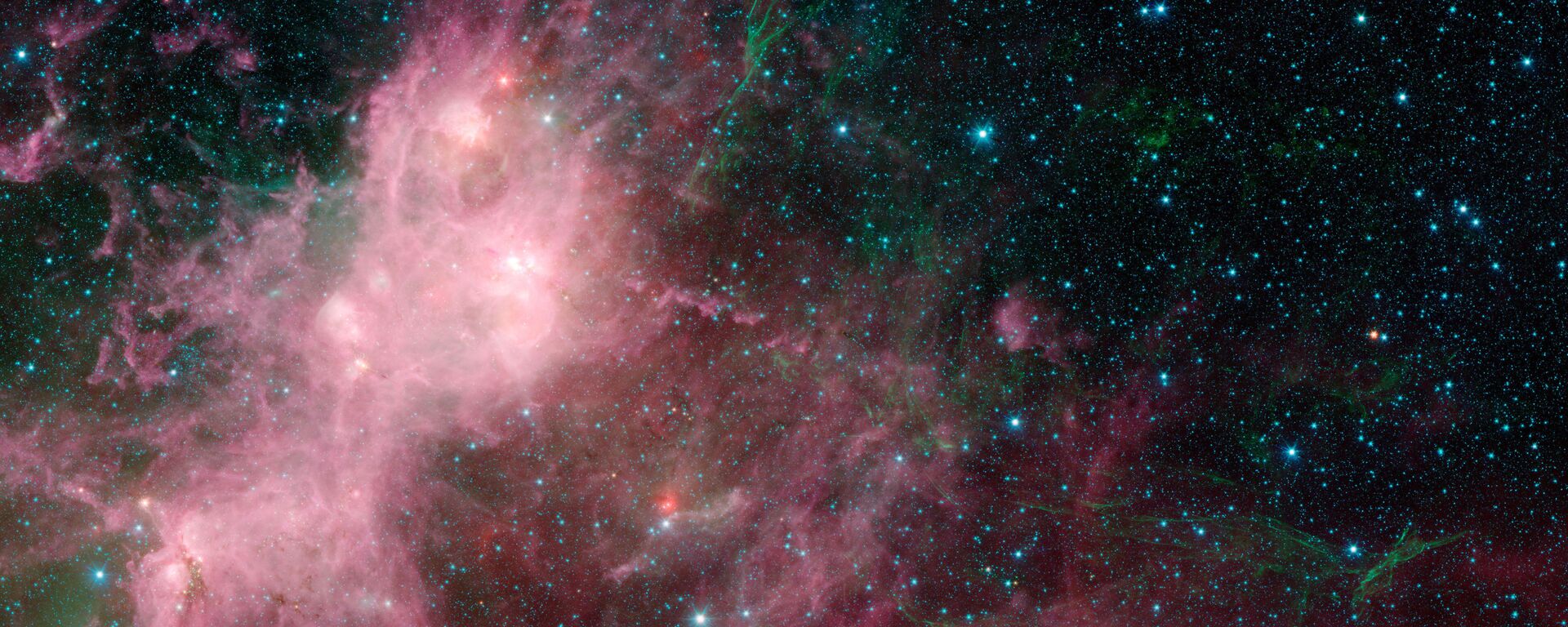 This image made available by NASA shows infrared data from the Spitzer Space Telescope and Wide-field Infrared Survey Explorer (WISE) in an area known as the W3 and W5 star-forming regions within the Milky Way Galaxy - Sputnik International, 1920, 25.03.2021