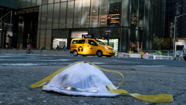 A face mask used to protect from the coronavirus disease (COVID-19) is seen on the ground near Trump Tower in New York City, New York, U.S., March 14, 2020 - Sputnik International