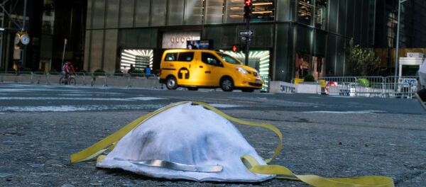 A face mask used to protect from the coronavirus disease (COVID-19) is seen on the ground near Trump Tower in New York City, New York, U.S., March 14, 2020 - Sputnik International