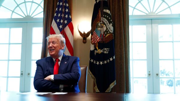 U.S. President Donald Trump laughs during a roundtable meeting with energy sector CEOs in the Cabinet Room of the White House in Washington, U.S., April 3, 2020 - Sputnik International