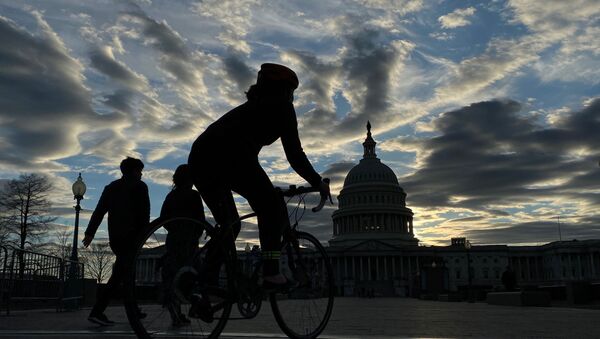 Walkers and cyclists take to the east front of the U.S. Capitol during the outbreak of the coronavirus disease (COVID-19), as personal exercise is exempted from the city-wide stay at home orders, in Washington, U.S. April 3, 2020.  - Sputnik International