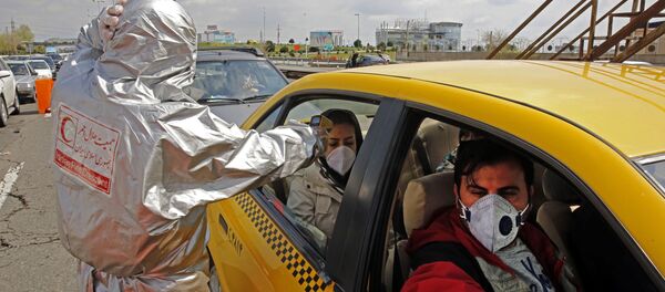 Members of the Iranian Red Crescent test people for coronavirus Covid-19 symptoms, as police blocked Tehran to Alborz highway to check every car following orders by the Iranian government, outside Tehran on March 26, 2020 Members of the Iranian Red Crescent test people for coronavirus Covid-19 symptoms, as police blocked Tehran to Alborz highway to check every car following orders by the Iranian government, outside Tehran on March 26, 2020 - Sputnik International