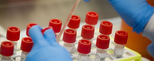A laboratory technician prepares COVID-19 patient samples for semi-automatic testing at Northwell Health Labs, Wednesday, March 11, 2020, in Lake Success, N.Y. The US Food and Drug Administration has approved faster testing protocols as the viral outbreak continues to spread worldwide. For most people, the new coronavirus causes only mild or moderate symptoms. For some it can cause more severe illness - Sputnik International