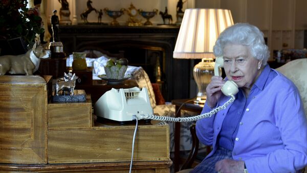 A handout picture released by Buckingham Palace on March 25, 2020 shows Britain's Queen Elizabeth II holding her weekly audience with Britain's Prime Minister Boris Johnson on the phone from Windsor Castle in Windsor, west of London on March 25, 2020. - Prince Charles, the eldest son and heir to Queen Elizabeth II, is showing mild symptoms of the new coronavirus and is self-isolating in Scotland, his office said on March 25. Clarence House said doctors believe Charles became contagious on March 13 -- a day after last meeting his mother. The 93-year-old queen has been staying with her 98-year-old husband Prince Philip at Windsor Castle, 640 miles (820 kilometres) south of Balmoral, since March 19 - Sputnik International