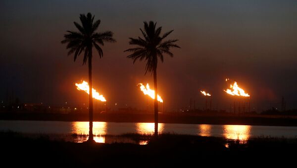 Flames emerge from flare stacks at Nahr Bin Umar oil field, north of Basra, Iraq March 9, 2020 - Sputnik International