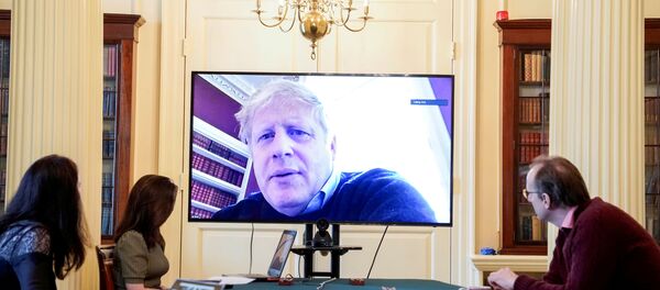 Britain's Prime Minister Boris Johnson appears on a monitor for the coronavirus disease (COVID-19) meeting in London, Britain March 28, 2020 Britain's Prime Minister Boris Johnson appears on a monitor for the coronavirus disease (COVID-19) meeting in London, Britain March 28, 2020 - Sputnik International