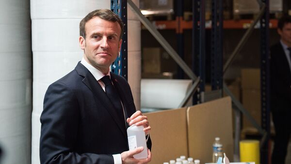 French President Emmanuel Macron washes his hands with sanitizer after a visit to the Kolmi-Hopen protective face masks factory, following an outbreak of the coronavirus disease (COVID-19), in Saint-Barthelemy-d'Anjou near Angers, France March 31, 2020. - Sputnik International