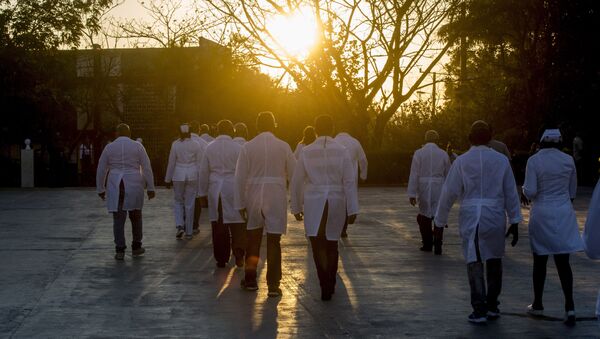 A brigade of health professionals, who volunteered to travel to the West Indies, walk back to their campus after posing for news photographers, in Havana, Cuba, Saturday, March 28, 2020. The medical teams will travel on Saturday to the dual-island country Saint Kitts and Nevis, to assist local authorities with an upsurge of COVID-19 cases. - Sputnik International
