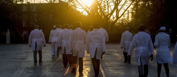 A brigade of health professionals, who volunteered to travel to the West Indies, walk back to their campus after posing for news photographers, in Havana, Cuba, Saturday, March 28, 2020. The medical teams will travel on Saturday to the dual-island country Saint Kitts and Nevis, to assist local authorities with an upsurge of COVID-19 cases. A brigade of health professionals, who volunteered to travel to the West Indies, walk back to their campus after posing for news photographers, in Havana, Cuba, Saturday, March 28, 2020. The medical teams will travel on Saturday to the dual-island country Saint Kitts and Nevis, to assist local authorities with an upsurge of COVID-19 cases. - Sputnik International