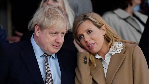 Rugby Union - Six Nations Championship - England v Wales - Twickenham Stadium, London, Britain - March 7, 2020  Britain's Prime Minister Boris Johnson with his partner Carrie Symonds after the match - Sputnik International