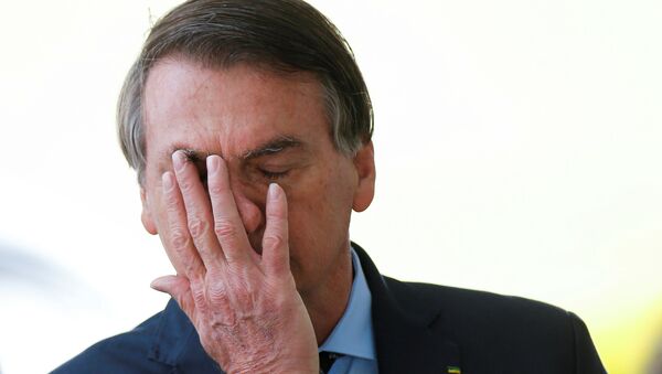Brazil's President Jair Bolsonaro reacts while meeting supporters as he leaves Alvorada Palace, amid the coronavirus disease (COVID-19) outbreak, in Brasilia, Brazil, April 9, 2020. - Sputnik International