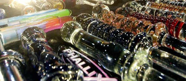 A woman looks at a glass dildo made by Phallix at the AVN Adult Entertainment Expo 09 January, 2004 in Las Vegas - Sputnik International