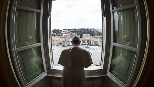This handout photo taken on March 29, 2020 and released by the Vatican press office, the Vatican Media, shows Pope Francis praying from the window of the Apostolic Palace overlooking an empty St. Peter' Square after his livestreamed the Angelus prayer on March 29, 2020 at the Vatican.  - Sputnik International