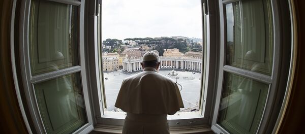 This handout photo taken on March 29, 2020 and released by the Vatican press office, the Vatican Media, shows Pope Francis praying from the window of the Apostolic Palace overlooking an empty St. Peter' Square after his livestreamed the Angelus prayer on March 29, 2020 at the Vatican.  - Sputnik International