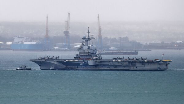 A picture taken on March 13, 2020, shows the French aircraft carrier Charles de Gaulle as it enters the port of Brest, in western France.  - Sputnik International