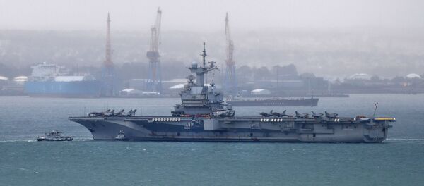 A picture taken on March 13, 2020, shows the French aircraft carrier Charles de Gaulle as it enters the port of Brest, in western France.  - Sputnik International