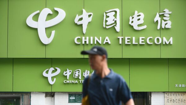 In this file a man walks past a China Telecom store in Wuhan, in central China's Hubei province on August 21, 2013. - Sputnik International