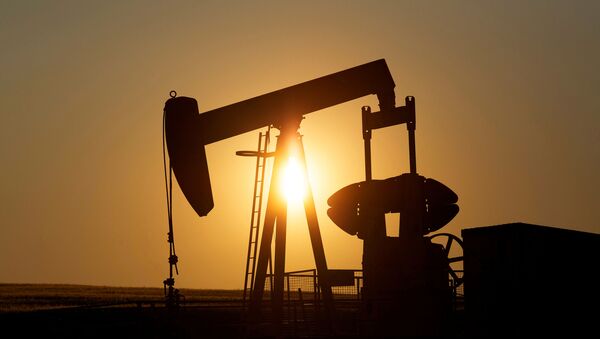 An oil pump jack pumps oil in a field near Calgary, Alberta, Canada on July 21, 2014 - Sputnik International