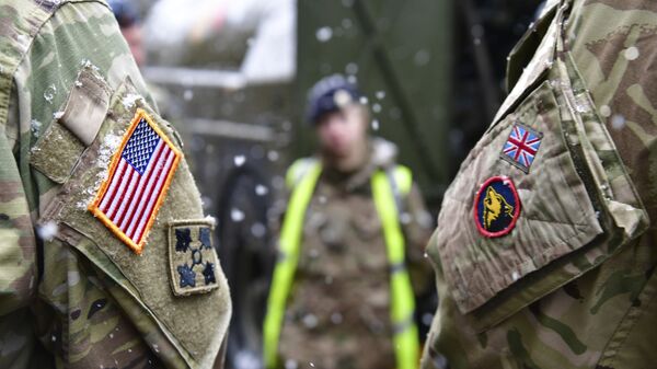 A British and an United States soldier stand side by side after a press conference on the military exercise 'Defender 2020' in Brueck, Germany, Wednesday, Feb. 26, 2020. The exercise with 37000 participants from a total of 18 nations will take place in Europe between January and about June 2020. - Sputnik International