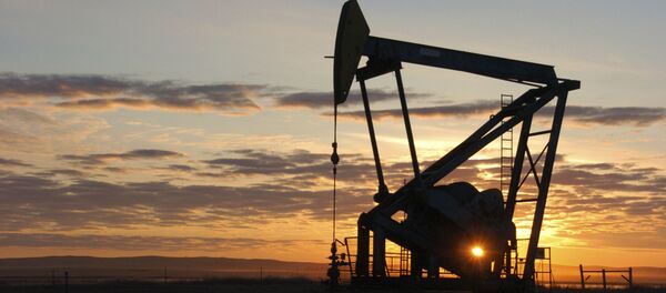 This Nov. 6, 2013 file photo shows a Whiting Petroleum Co. pump jack pulls crude oil from the Bakken region of the Northern Plains near Bainville, Mont. This Nov. 6, 2013 file photo shows a Whiting Petroleum Co. pump jack pulls crude oil from the Bakken region of the Northern Plains near Bainville, Mont. - Sputnik International