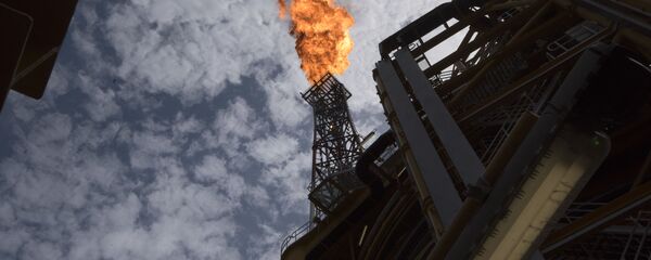 A view of the flare of the Kaombo Norte, an oil tanker converted into a FPSO vessel (Floating Production Storage and Offloading), owned by the French Total oil company, on November 8, 2018, about 250km off the coast of Angola in the Atlantic Ocean.  - Sputnik International