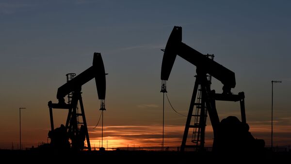 Pump jacks operate at sunset in an oil field in Midland, Texas U.S. August 22, 2018. Picture taken August 22, 2018 - Sputnik International