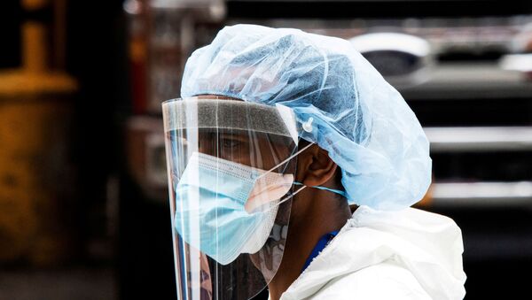A person wearing a PPE suit exits the Elmhurst Hospital center as the outbreak of coronavirus disease (COVID-19) continues in the neighborhood of Queens in New York, U.S., April 5, 2020. - Sputnik International