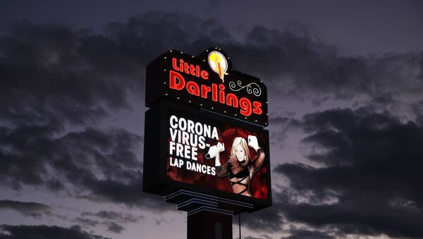 A sign at a strip club advertises coronavirus-free lap dances Friday, March 13, 2020, in Las Vegas.  - Sputnik International