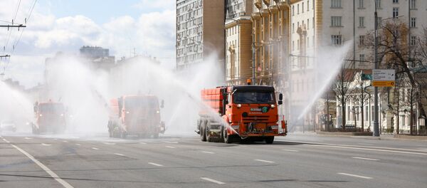 Vehicles drive near the U.S. embassy and spray disinfectant while sanitizing a road to prevent the spread of the coronavirus disease (COVID-19) in Moscow, Russia April 12, 2020 - Sputnik International