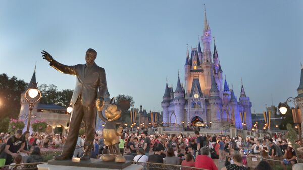 In this Wednesday, Jan. 15, 2020 photo, a statue of Walt Disney and Mickey Mouse is seen in front of the Cinderella Castle at the Magic Kingdom theme park at Walt Disney World in Lake Buena Vista, Fla. Florida tourism officials say cases of the new coronavirus are having little visible impact on the theme park industry so far.  - Sputnik International