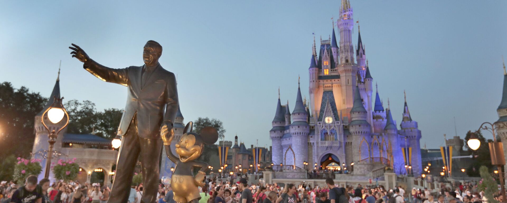 In this Wednesday, Jan. 15, 2020 photo, a statue of Walt Disney and Mickey Mouse is seen in front of the Cinderella Castle at the Magic Kingdom theme park at Walt Disney World in Lake Buena Vista, Fla. Florida tourism officials say cases of the new coronavirus are having little visible impact on the theme park industry so far.  - Sputnik International, 1920