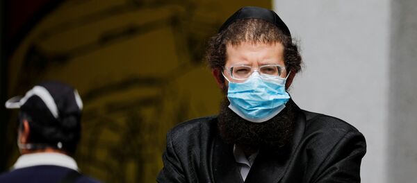 An ultra-Orthodox Jewish man wearing a mask looks on in Bnei Brak, a town badly affected by the coronavirus disease (COVID-19), and which Israel declared a restricted zone due to its high rate of infections, near Tel Aviv, Israel April 5, 2020 An ultra-Orthodox Jewish man wearing a mask looks on in Bnei Brak, a town badly affected by the coronavirus disease (COVID-19), and which Israel declared a restricted zone due to its high rate of infections, near Tel Aviv, Israel April 5, 2020 - Sputnik International