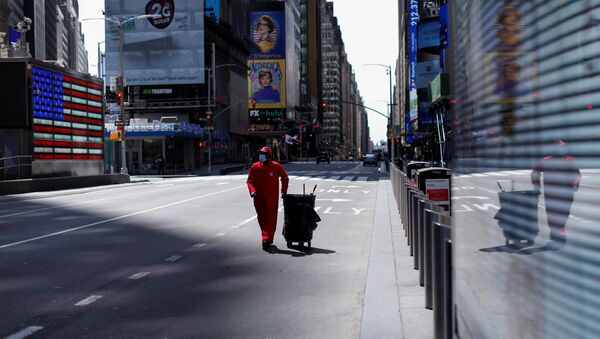 A Times Square Alliance street sweeper worker walks though a nearly empty Times Square in Manhattan during the outbreak of the coronavirus disease (COVID-19) in New York City, New York, U.S., April 7, 2020. - Sputnik International
