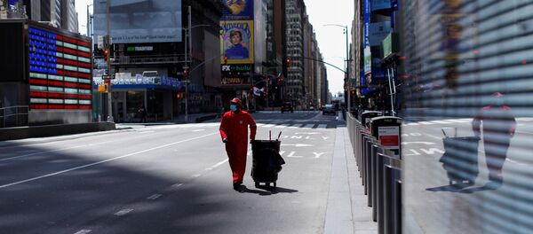 A Times Square Alliance street sweeper worker walks though a nearly empty Times Square in Manhattan during the outbreak of the coronavirus disease (COVID-19) in New York City, New York, U.S., April 7, 2020. - Sputnik International