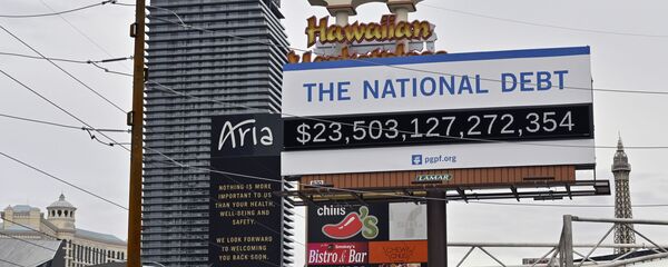 A billboard displaying the U.S. national debt is displayed along the Las Vegas Strip, Wednesday, March 18, 2020 - Sputnik International