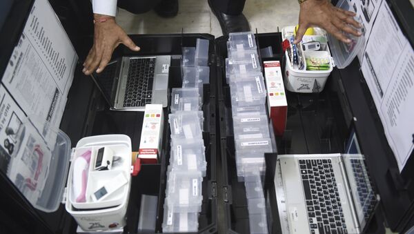 Scientist and founder of Online Telemedicine Research Institute, Ragesh Shah checks the contents of the kits prepared for the coronavirus scanning and surveillance system, in Ahmedabad on March 6, 2020.  - Sputnik International
