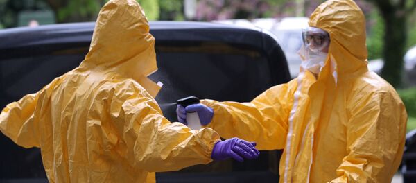 Mortuary employees use disinfectant standing outside an elderly residence following the coronavirus disease (COVID-19) outbreak - Sputnik International