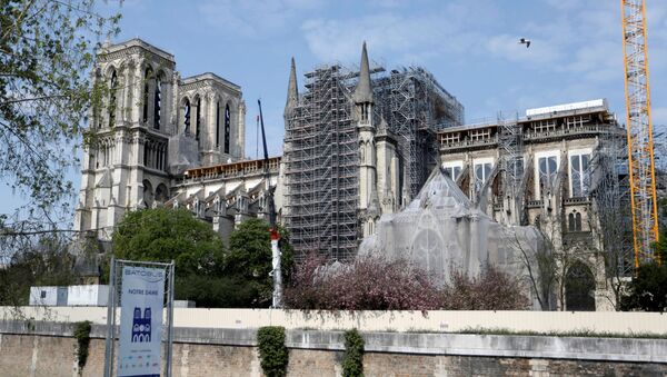A view shows the Notre-Dame de Paris Cathedral, which was damaged in a devastating fire one year ago, as the coronavirus disease (COVID-19) lockdown slows down its restoration in Paris, France, April 11, 2020 - Sputnik International