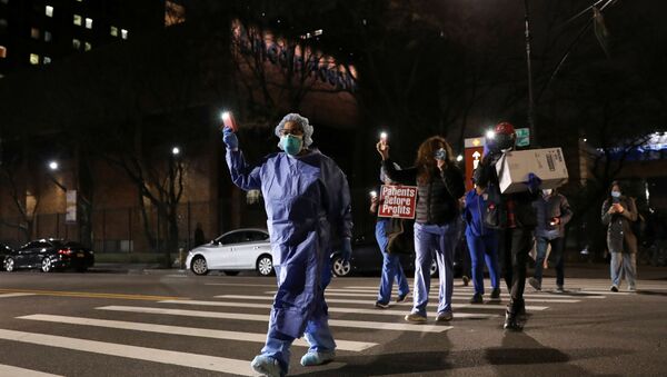 Nurses gather for a candlelight vigil to honor healthcare workers, during the outbreak of the coronavirus disease (COVID-19) at Lincoln Hospital in the Bronx borough of New York City, U.S., April 14, 2020 - Sputnik International