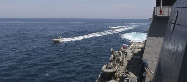 In this Wednesday, April 15, 2020, photo made available by U.S. Navy, Iranian Revolutionary Guard vessels sail close to U.S. military ships in the Persian Gulf near Kuwait In this Wednesday, April 15, 2020, photo made available by U.S. Navy, Iranian Revolutionary Guard vessels sail close to U.S. military ships in the Persian Gulf near Kuwait - Sputnik International