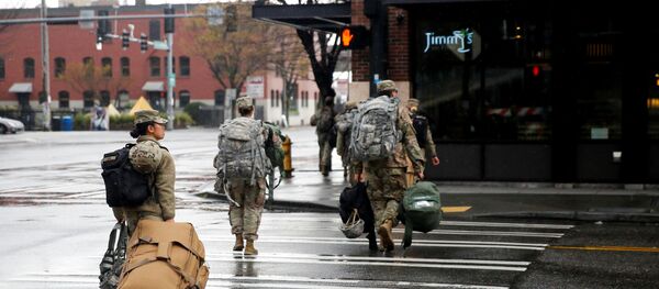 Soldiers from the 627th Army Hospital from Fort Carson, Colorado walk across the street after working at CenturyLink Field Event Center, which is being turned into a military field hospital for non coronavirus patients during the coronavirus disease (COVID-19) outbreak in Seattle, Washington, U.S. March 30, 2020 - Sputnik International