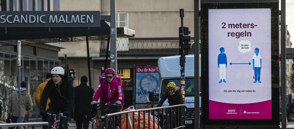 An advertisement of the healthcare services of Sweden instructs people to follow the 2 meters rule to reduce the risk of getting sick, in Stockholm on April 14, 2020. - Sputnik International