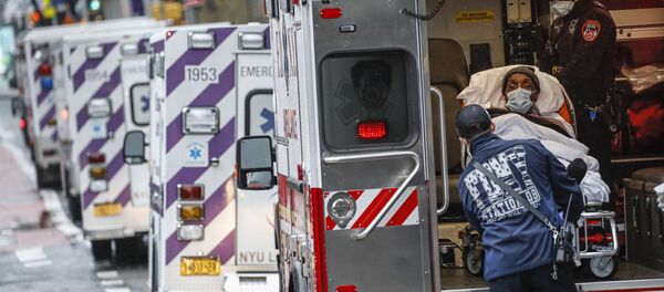 In this Monday, April 13, 2020 file photo, a patient arrives in an ambulance cared for by medical workers wearing personal protective equipment due to COVID-19 coronavirus concerns outside NYU Langone Medical Center in New York - Sputnik International