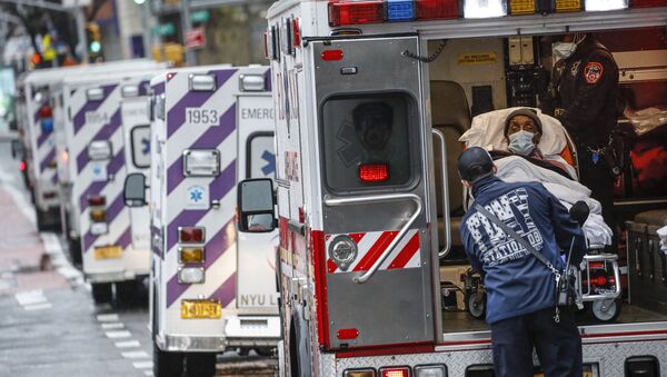 In this Monday, April 13, 2020 file photo, a patient arrives in an ambulance cared for by medical workers wearing personal protective equipment due to COVID-19 coronavirus concerns outside NYU Langone Medical Center in New York - Sputnik International