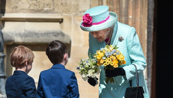 Britain's Queen Elizabeth II smiles as she receives posies of flowers from children after attending the Easter Mattins Service at St. George's Chapel, Windsor Castle on April 21, 2019. - Sputnik International