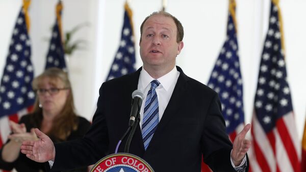 Colorado Governor Jared Polis makes a point during a news conference to update the state's efforts to control the spread of the new coronavirus Friday, April 17, 2020, at the governor's mansion in Denver. - Sputnik International