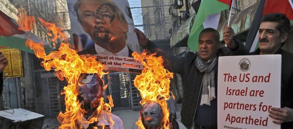 Demonstrators wave Palestinian flags as they burn effigies of US President Donald Trump and Israeli Prime Minister Benjamin Netanyahu during a protest against Trump's proposed Israeli-Palestinian peace plan, dubbed as the deal of the century, outside an Israeli checkpoint in the flashpoint city of Hebron in the occupied West Bank on February 28, 2020. Demonstrators wave Palestinian flags as they burn effigies of US President Donald Trump and Israeli Prime Minister Benjamin Netanyahu during a protest against Trump's proposed Israeli-Palestinian peace plan, dubbed as the deal of the century, outside an Israeli checkpoint in the flashpoint city of Hebron in the occupied West Bank on February 28, 2020. - Sputnik International